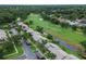 Panoramic aerial shot showcases the condo community, adjacent to the golf course and tree-lined streets at 140 Dale Pl, Oldsmar, FL 34677