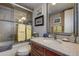 Bright bathroom with a granite counter, decorative mirror and tiled shower with glass door at 140 Dale Pl, Oldsmar, FL 34677