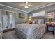 Relaxing bedroom featuring a plush bed, ceiling fan and sliding glass door at 140 Dale Pl, Oldsmar, FL 34677