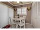 Bright breakfast nook features white table set, plantation shutters and tile flooring for casual dining at 140 Dale Pl, Oldsmar, FL 34677