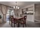 Cozy dining room with modern chandelier, patio access, and view to kitchen at 140 Dale Pl, Oldsmar, FL 34677