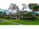 Charming single-story home featuring lush landscaping and a well-manicured lawn in a serene neighborhood at 140 Dale Pl, Oldsmar, FL 34677