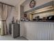 View of the kitchen with white cabinets, granite countertops, and stainless steel appliances at 140 Dale Pl, Oldsmar, FL 34677