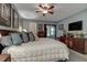 Well-lit main bedroom with a ceiling fan, plush carpet, and sliding doors leading to a lanai at 140 Dale Pl, Oldsmar, FL 34677