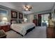 Spacious main bedroom with a ceiling fan, soft carpet, and large sliding doors leading to the lanai at 140 Dale Pl, Oldsmar, FL 34677