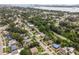 Aerial view showcasing a residential neighborhood near a body of water with a city skyline in the distance at 1743 Fulton Ave, Clearwater, FL 33755