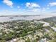 Breathtaking aerial view of a neighborhood near a bay, showcasing lush trees and beautiful water views at 1743 Fulton Ave, Clearwater, FL 33755