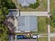 Aerial view of the property showing the roof, long driveway, and surrounding landscape and neighborhood at 1743 Fulton Ave, Clearwater, FL 33755