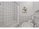 Bathroom featuring a tub and a shower with black and white tiles at 1743 Fulton Ave, Clearwater, FL 33755