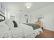 Spacious bedroom with hardwood floors, white bedding, and closet at 1743 Fulton Ave, Clearwater, FL 33755