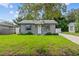 Charming home featuring a freshly cut lawn and new, clean exterior paint at 1743 Fulton Ave, Clearwater, FL 33755