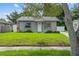 Inviting front yard with lush green grass and mature trees at 1743 Fulton Ave, Clearwater, FL 33755