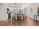 A bright kitchen featuring white cabinets, stainless steel appliances, and a modern island with stools at 1743 Fulton Ave, Clearwater, FL 33755