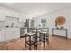 Bright eat-in kitchen featuring white cabinets, stainless steel appliances, and a modern island with stools at 1743 Fulton Ave, Clearwater, FL 33755