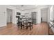 Eat-in kitchen featuring stainless appliances, tile backsplash, and modern fixtures at 1743 Fulton Ave, Clearwater, FL 33755