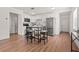 Bright kitchen with white cabinets, stainless steel appliances, and a breakfast table with seating at 1743 Fulton Ave, Clearwater, FL 33755