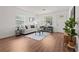 Bright living room with modern furniture, wood floors, and a white front door at 1743 Fulton Ave, Clearwater, FL 33755