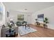Bright living room with a white front door, wood floors and cozy furnishings at 1743 Fulton Ave, Clearwater, FL 33755