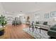 Open-concept living space with modern decor, wood floors, and an eat-in kitchen at 1743 Fulton Ave, Clearwater, FL 33755