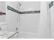 Bathroom with shower and white tile and decorative accent tile at 1813 Bough Ave # B, Clearwater, FL 33760