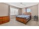 Bedroom with neutral walls, carpet, ceiling fan, and wood furnishings at 1813 Bough Ave # B, Clearwater, FL 33760