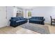 Bright living room with tile floor, neutral walls, large windows, and comfortable seating with a gray rug at 1813 Bough Ave # B, Clearwater, FL 33760