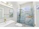 Stylish bathroom with blue tiled shower and contemporary fixtures, complemented by natural light at 19113 Golden Cacoon Pl, Lutz, FL 33558