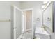 Elegant bathroom featuring a sleek white vanity, modern fixtures, and marble-like tiled flooring at 19113 Golden Cacoon Pl, Lutz, FL 33558