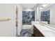 Elegant bathroom showcasing modern fixtures, marble-like tile, and dual vanity sinks at 19113 Golden Cacoon Pl, Lutz, FL 33558