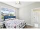 Cozy bedroom with bright light, featuring a large window and neutral wall color scheme at 19113 Golden Cacoon Pl, Lutz, FL 33558