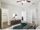 Bright bedroom with ceiling fan, walk-in closet, and ensuite bathroom at 19113 Golden Cacoon Pl, Lutz, FL 33558