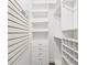 Walk-in closet with custom shelving and organization system at 19113 Golden Cacoon Pl, Lutz, FL 33558
