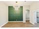 Dining area featuring a statement light fixture and decorative accent wall at 19113 Golden Cacoon Pl, Lutz, FL 33558