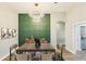 Elegant dining room with a unique chandelier and designer accent wall provides a charming space at 19113 Golden Cacoon Pl, Lutz, FL 33558