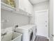 Laundry room with washer, dryer, and storage cabinets at 19113 Golden Cacoon Pl, Lutz, FL 33558