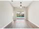 Open-concept living area featuring sliding glass doors to the pool, and new floors at 19113 Golden Cacoon Pl, Lutz, FL 33558