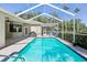Sparkling pool area under a screened enclosure, complete with outdoor seating and well-maintained landscaping at 19113 Golden Cacoon Pl, Lutz, FL 33558