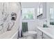 Bright bathroom with tub and shower combination, marble tile wall, and white vanity at 2026 Union S St, St Petersburg, FL 33712