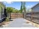 Private driveway gate with secure wood fencing providing backyard access at 2026 Union S St, St Petersburg, FL 33712