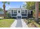 Charming bungalow with gray siding, white trim, well-kept lawn, and a decorative walkway leading to the front door at 2026 Union S St, St Petersburg, FL 33712