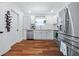 Bright, modern kitchen featuring white cabinetry, stainless steel appliances, wood floors, and ample counter space at 2026 Union S St, St Petersburg, FL 33712