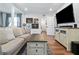 Bright living room featuring neutral walls, wood flooring, a comfortable sofa, and a modern entertainment center at 2026 Union S St, St Petersburg, FL 33712
