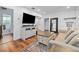 Comfortable living room featuring a modern entertainment center, wood floors, and a neutral color palette at 2026 Union S St, St Petersburg, FL 33712