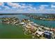 Beautiful aerial view of a waterfront home with dock, surrounded by scenic water and landscaping at 208 Bath Club N Blvd, North Redington Beach, FL 33708