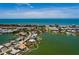 Aerial view of waterfront home with dock, and bay access and proximity to a city and beach at 208 Bath Club N Blvd, North Redington Beach, FL 33708
