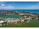 Aerial view showcasing waterfront homes with dock, bay access, and community amenities at 208 Bath Club N Blvd, North Redington Beach, FL 33708