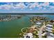 Aerial view showcasing the home's location on the waterfront, with a private dock and surrounding neighborhood at 208 Bath Club N Blvd, North Redington Beach, FL 33708