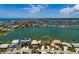 Scenic aerial shot of the property highlighting its waterfront location and lush, green surroundings at 208 Bath Club N Blvd, North Redington Beach, FL 33708