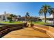 View of the backyard with a wooden dock with benches at the bay at 208 Bath Club N Blvd, North Redington Beach, FL 33708