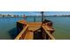 Close up of a wooden dock with built-in benches overlooking the peaceful waterfront at 208 Bath Club N Blvd, North Redington Beach, FL 33708